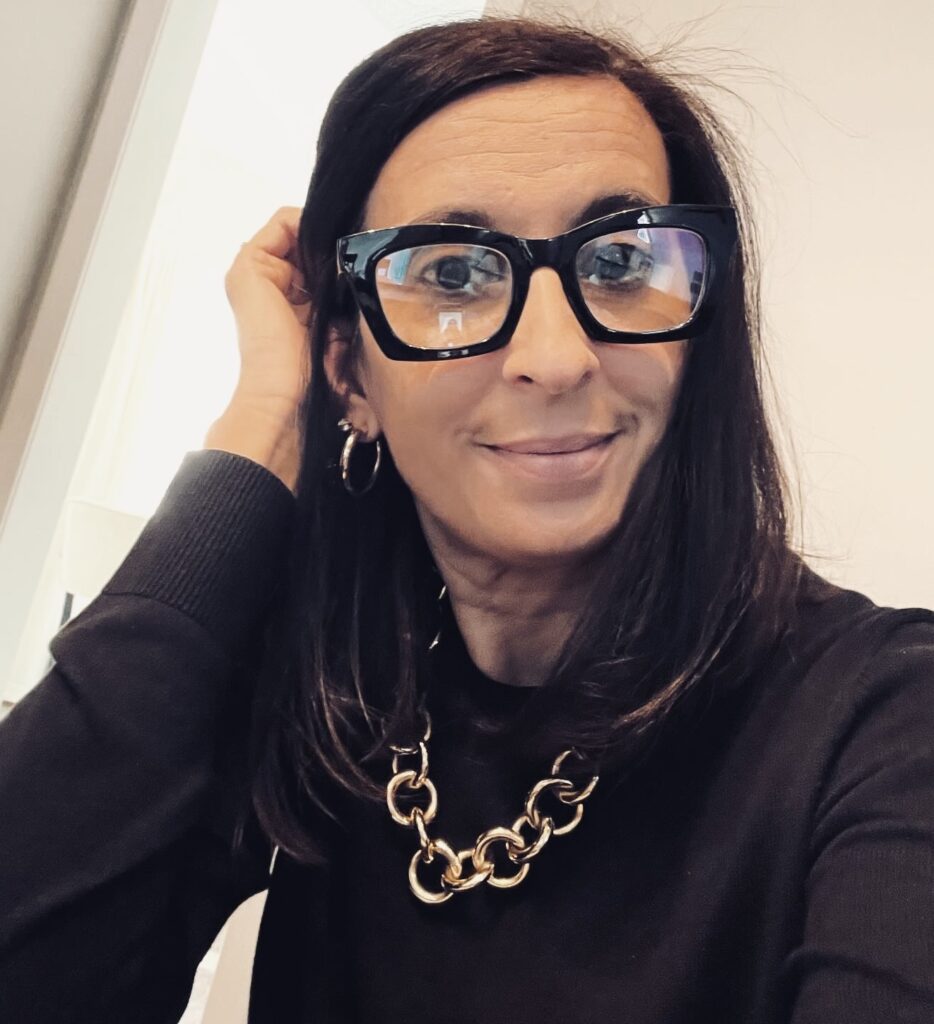 A woman in glass looking at the camera